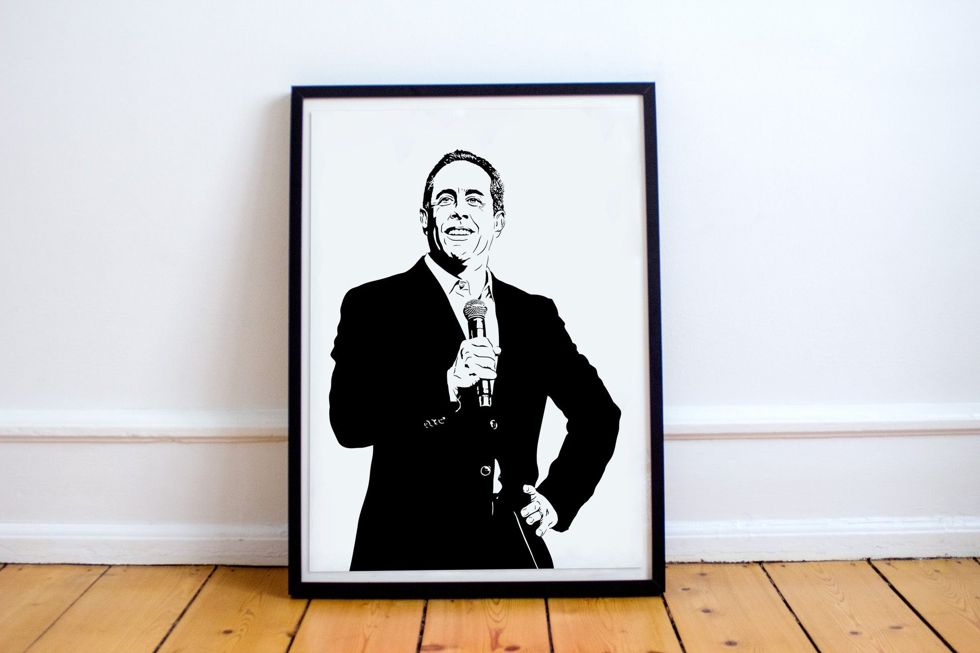 black and white digital illustration of jerry seinfeld performing stand-up comedy on stage with a microphone framed print