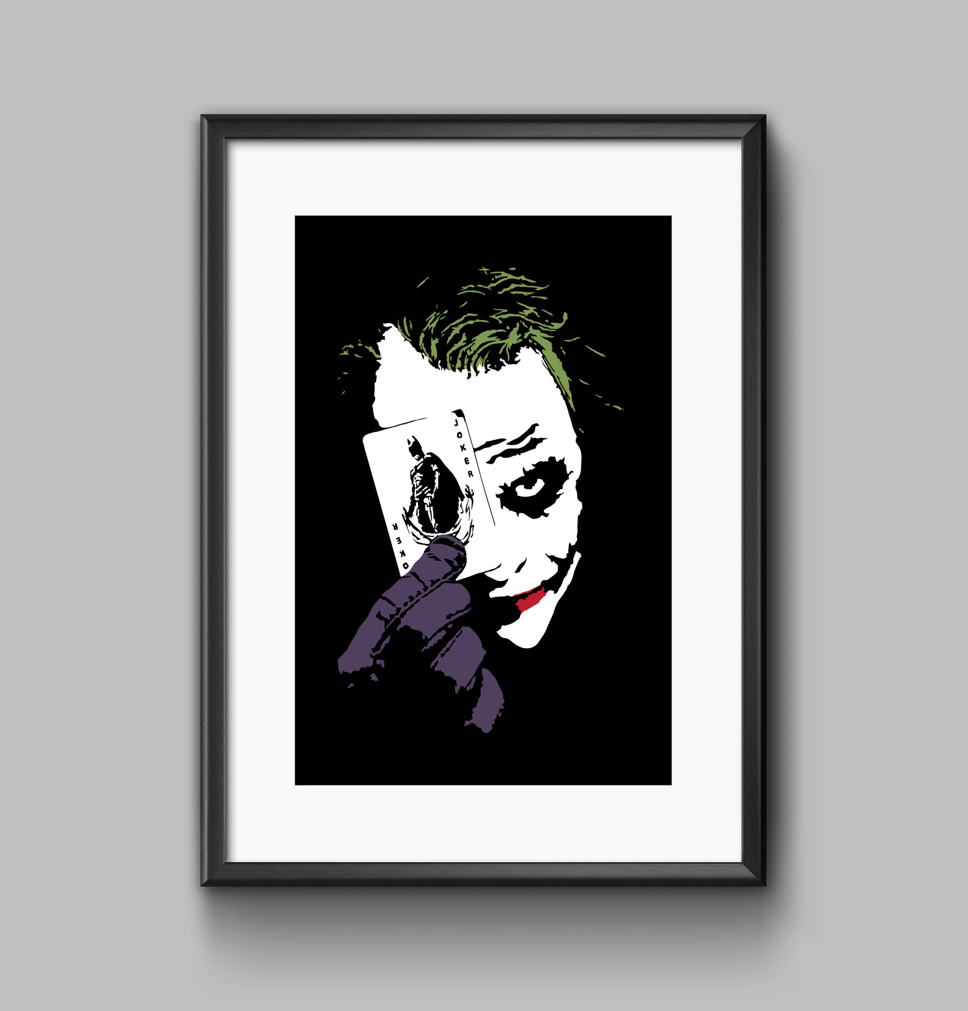 black and white digital illustration with spot colors close up portrait of heath ledger as the joker holding a playing card framed print