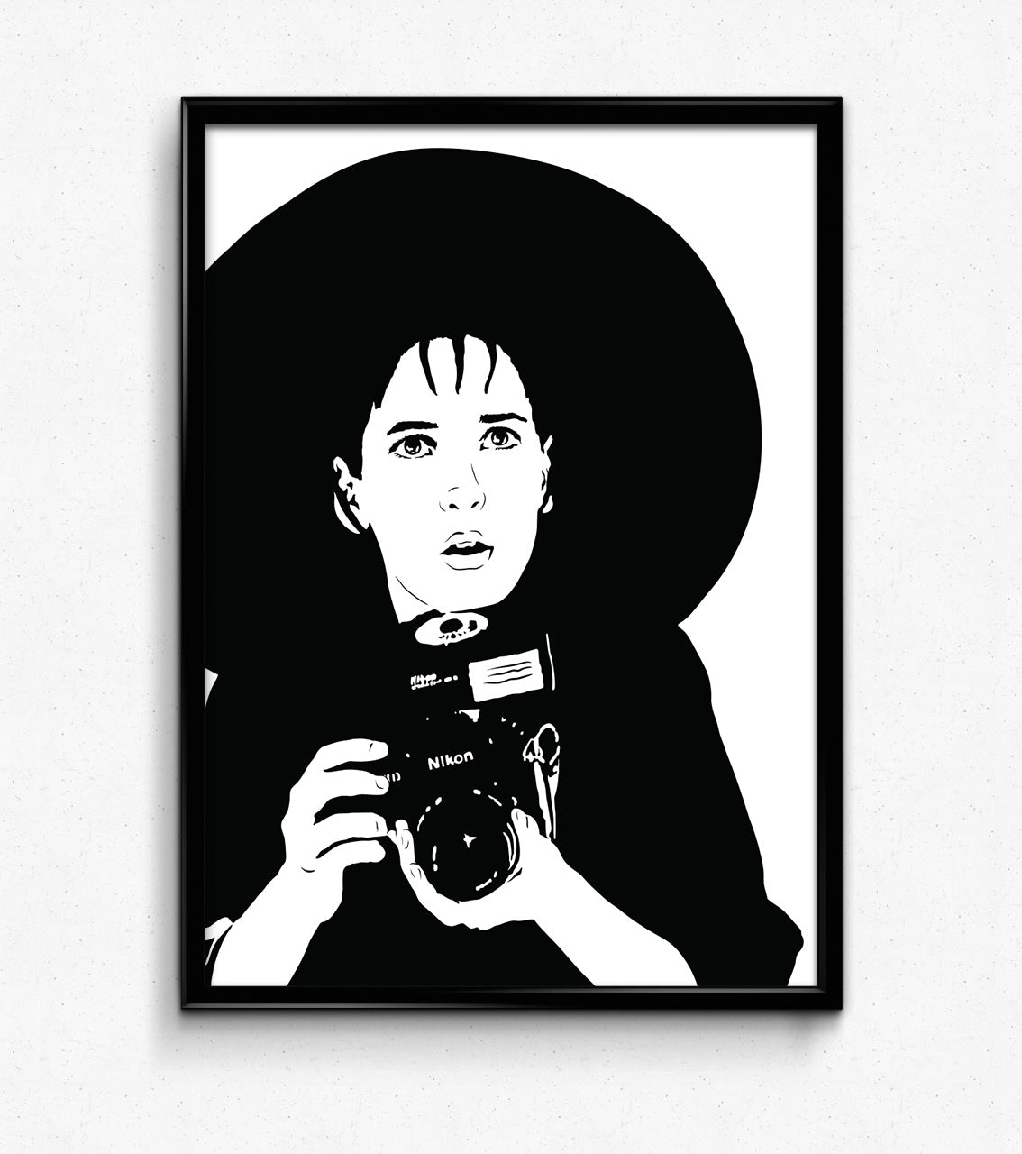 black and white illustration of lydia deetz from beetlejuice film played by winona ryder holding a nikon camera in a goth fashion outfit with a very large brimmed black hat framed art print